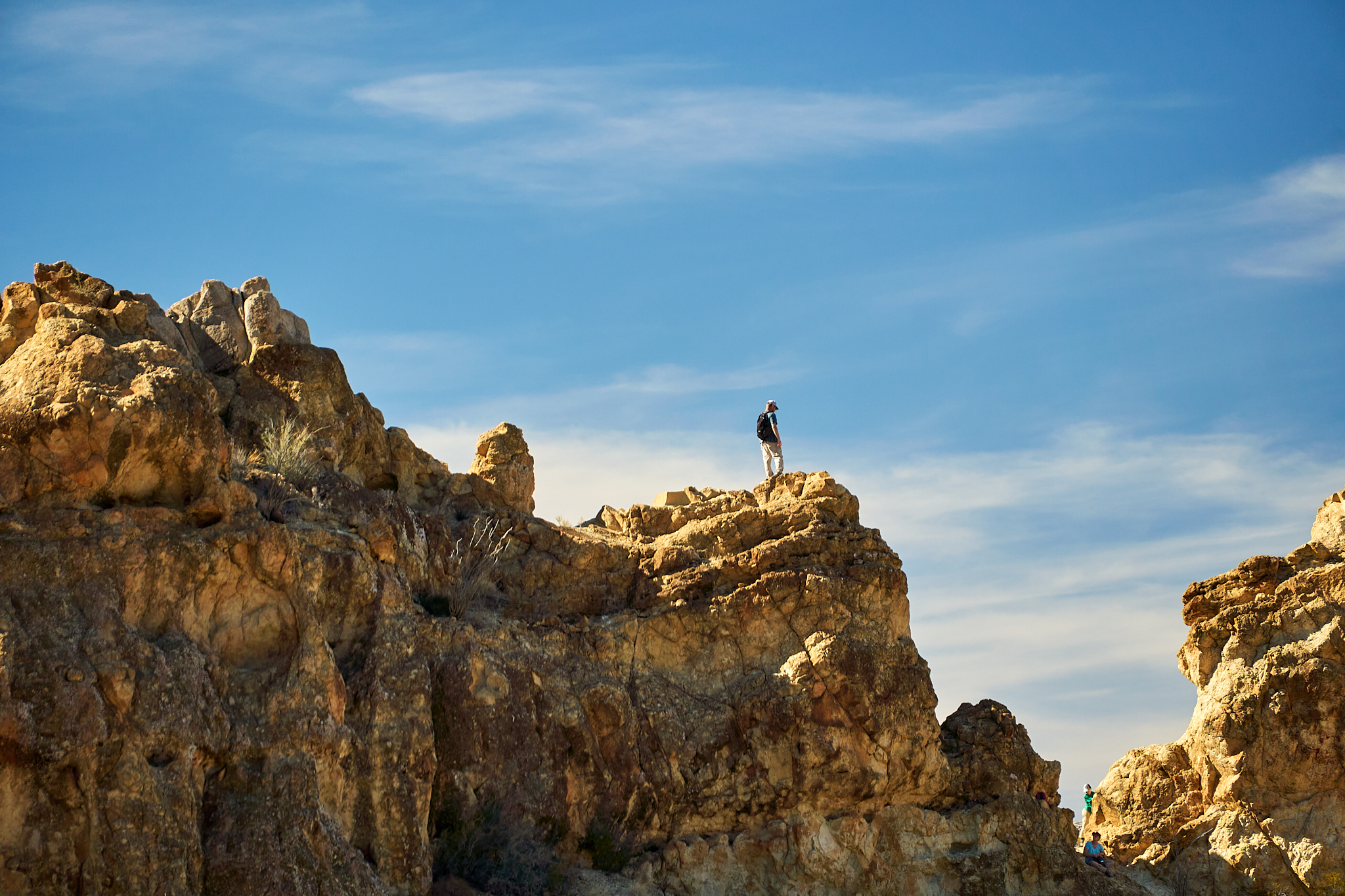 Hiker standing on a rocky cliff outcrop