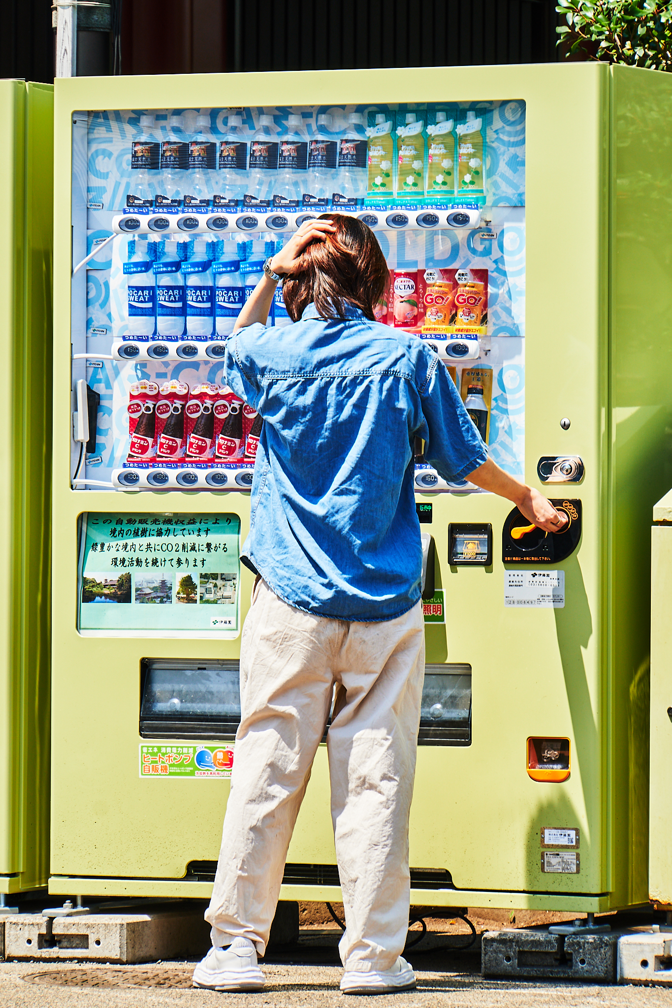 Person choosing a drink from a vending machine